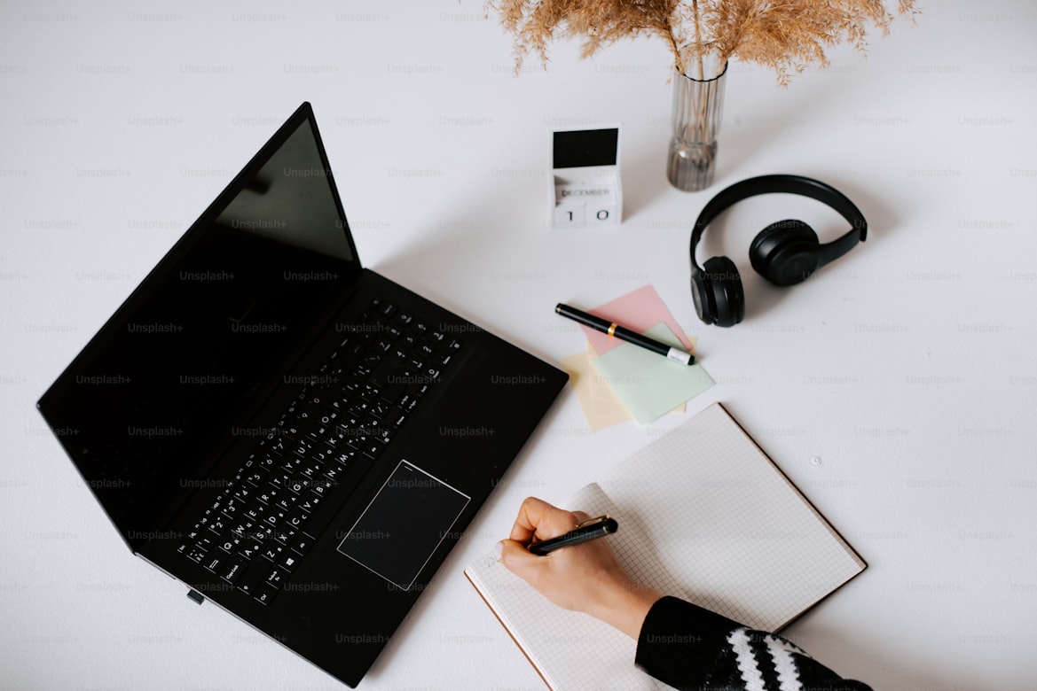 Hands writing in notebook
